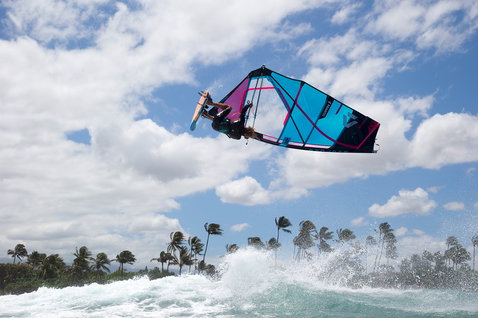 Fanatic FreeWave TE windsurf board during wave windsurfing with aerial manoeuvre above breaking ocean wave
