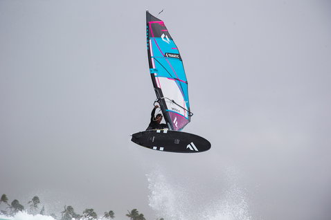 Fanatic FreeWave TeXtreme windsurf board during wave riding with aerial jump over the ocean
