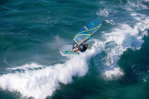 Fanatic Stubby TE Wave-Windsurfboard beim Wellenreiten im Ozean aus der Vogelperspektive