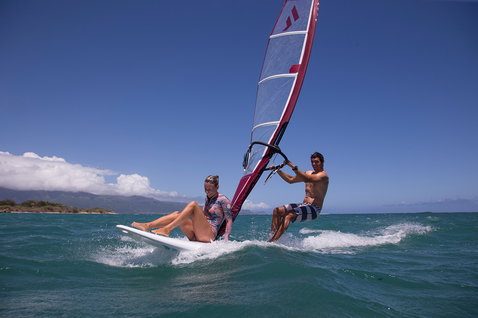 Fanatic Viper windsurf board during windsurfing on tropical turquoise ocean with two riders