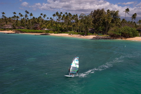 Fanatic Gecko HRS freeride windsurf board during windsurfing on turquoise tropical ocean waters