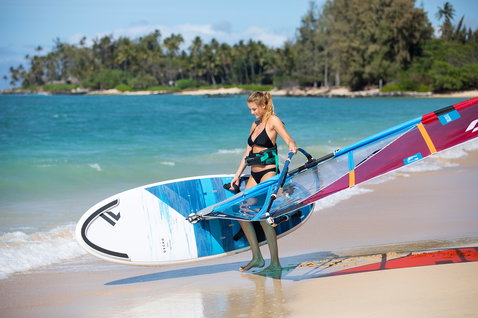 Fanatic Gecko HRS Soft Top Daggerboard windsurf board carried on a tropical beach during windsurfing