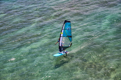 Fanatic Stingray LTD windsurf foil board during foiling over turquoise shallow water