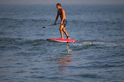 Fanatic Sky SUP foil board during SUP foiling on the ocean at golden hour