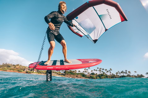 Fanatic Sky SUP foil board 6'7" in coral red during wing foiling on tropical ocean
