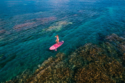 Duotone Diamond Air inflatable SUP board during stand up paddling over coral reef in Maui