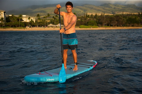 Fanatic Fly Air inflatable SUP board during stand-up paddleboarding on the ocean at golden hour