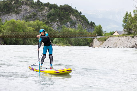 Fanatic Rapid Air Touring inflatable SUP board 11" in yellow during river touring on an alpine river