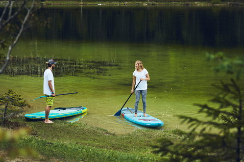 Fanatic Ray Air inflatable touring SUP board during paddling on a calm lake in summer