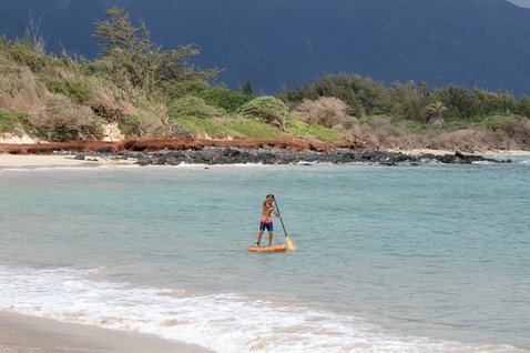 Duotone Ripper Air Touring inflatable kids SUP board 10'0" in orange during paddling on the ocean