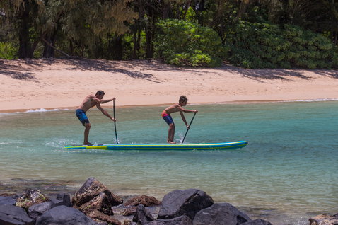 Duotone Tandem Air Premium inflatable SUP board during stand up paddling on a tropical lagoon