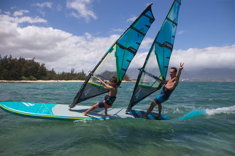 Duotone Tandem Air Premium inflatable SUP board during tandem windsurfing on the ocean