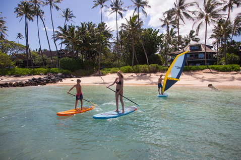 Duotone Viper Air inflatable SUP and windsurf board during paddleboarding and windsurfing at a tropical beach lagoon