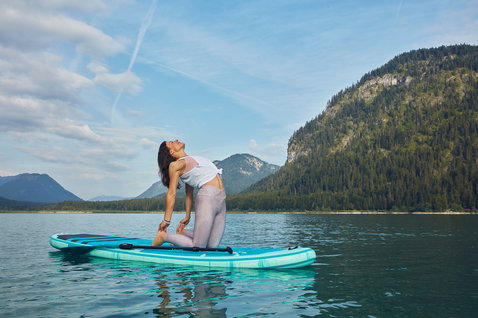 Duotone Fly Air Fit inflatable SUP board 10'6" during SUP yoga on an alpine lake