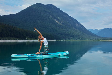 Duotone Fly Air Fit inflatable SUP board 10'6" during SUP yoga on a mountain lake