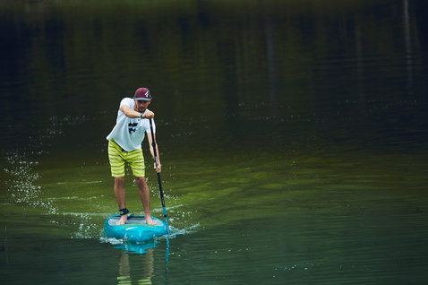 Duotone Ray LTD composite SUP touring board 12'6" during stand-up paddling on calm water in teal