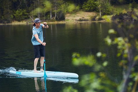 Duotone Ray Pure SUP board 12'6" during stand up paddling on a calm mountain lake