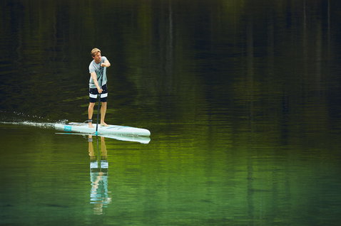 Duotone Ray Pure Light SUP composite board 12'6"x28.5" during stand up paddling on a calm forest lake