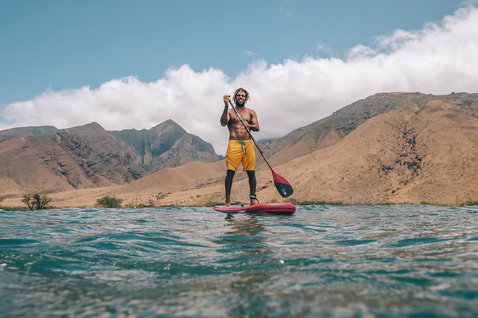 Duotone SUP Carbon 80 Adjustable 3-piece paddle during stand-up paddleboarding on the ocean with mountain backdrop