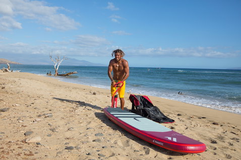 Duotone SUP Stubby Air inflatable wave SUP board 8'6" in dark red and mint green at the beach