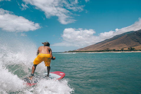 Duotone Stubby Air inflatable wave SUP 8'6" during SUP surfing on the ocean with mountain coastline