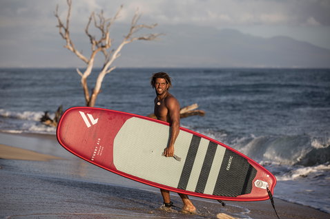 Fanatic Stubby Air inflatable wave SUP board 8'6" in red during stand up paddle surfing at the beach