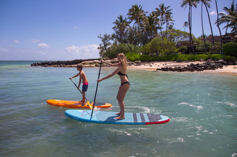 Duotone Fly Air inflatable SUP board during stand up paddling at a tropical beach