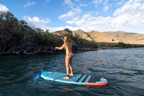 Duotone Fly Air inflatable SUP board during stand up paddling in a calm coastal bay
