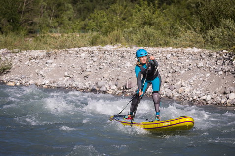 Fanatic Rapid Air Touring inflatable SUP board during whitewater paddling on a mountain river