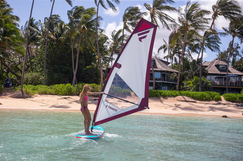 Fanatic Ride SUP windsurf rig during windsurfing on a tropical lagoon with white and burgundy sail