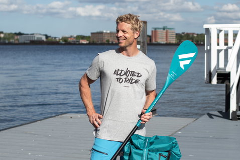 Fanatic Addicted To Ride short sleeve tee in heather grey during watersports at the harbour