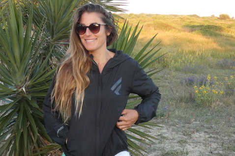 Fanatic Windbreaker Jacket Women worn outdoors in black with hood at golden hour
