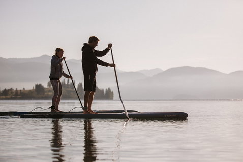 Fanatic Ray Bamboo Edition SUP touring board 12'6" during paddling on a calm mountain lake