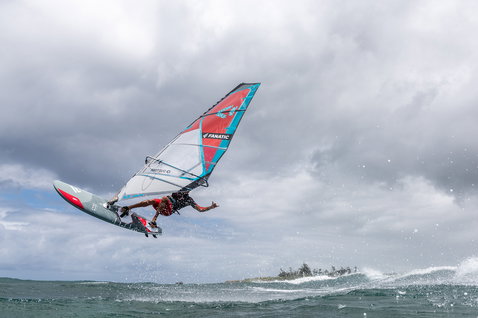 Fanatic FreeWave TeXtreme windsurf board during wave riding on the ocean with aerial manoeuvre