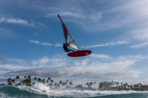 Fanatic FreeWave TE wave windsurf board during wave jump over tropical ocean