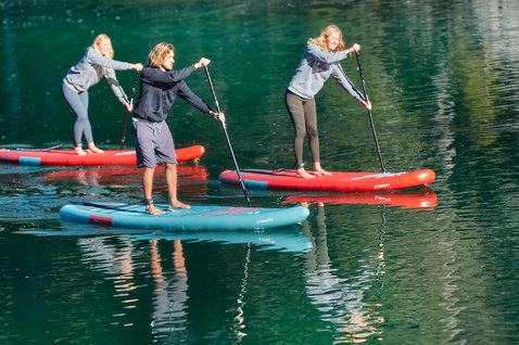 Duotone SUP Fly Air inflatable SUP board during stand up paddling on calm lake