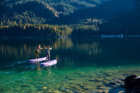Duotone SUP Diamond Air Pocket inflatable SUP board during stand-up paddling on an alpine lake