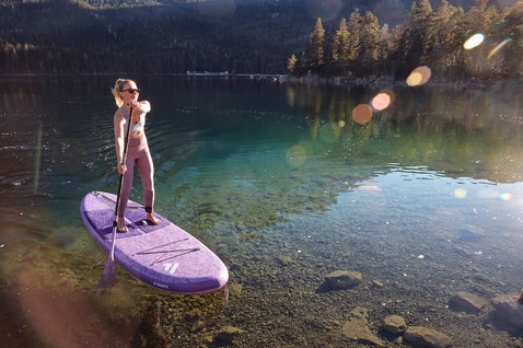 Fanatic Diamond Air Pocket inflatable SUP board 10'4" in purple during stand up paddling on an alpine lake