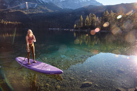 Fanatic Diamond Air Touring Pocket inflatable SUP touring board during stand-up paddling on an alpine lake