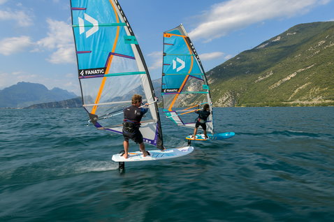 Fanatic Stingray foil windsurf board during wind foiling on an alpine lake with two riders