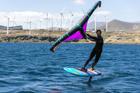 Fanatic Stingray LTD foil board during wing foiling on the ocean with Duotone wing in teal and orange