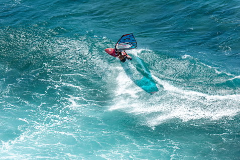 Fanatic Grip TE windsurf wave board during wave riding on the ocean, aerial view