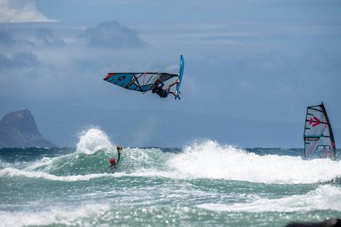 Fanatic FreeWave TE windsurf board during wave riding on the ocean with aerial maneuver