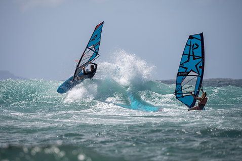 Fanatic FreeWave TE windsurf board during wave riding on the ocean with two riders
