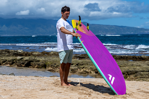 Fanatic Mamba TE Wave-Windsurf-Board beim Wellenreiten am Strand in magenta, gelb und türkis