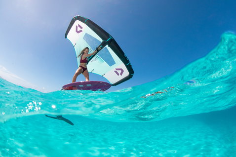 Fanatic Sky Wing foil board during wing foiling in tropical ocean with Duotone Slick wing in cyan and navy