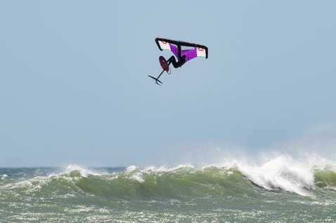 Fanatic Sky Wing foil board during wing foiling aerial maneuver over ocean waves