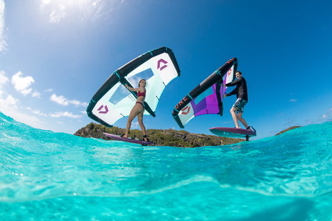 Fanatic Sky Wing foil board during wing foiling in tropical ocean waters with two riders and Duotone wings