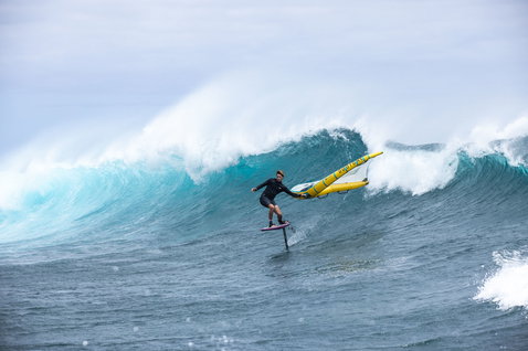 Fanatic Duotone Carbon TE mast and fuselage set during wing foiling on the open ocean with breaking wave
