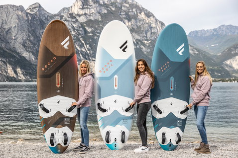 Fanatic Gecko Eco freeride windsurf board in brown, white and teal — three sizes at alpine lake